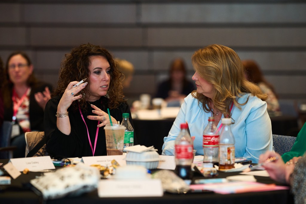 Two CUWLA members are engrossed in a conversation.