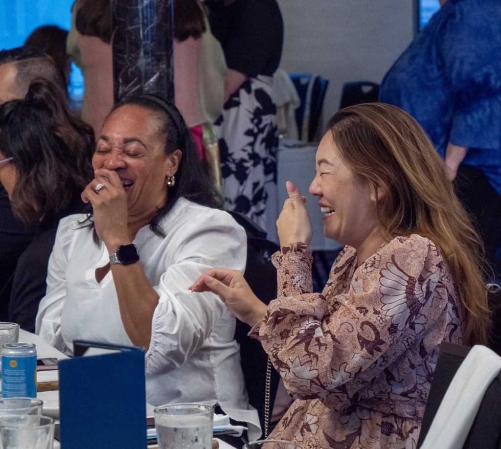 Two CEOs laughing hysterically at a CUWLA event